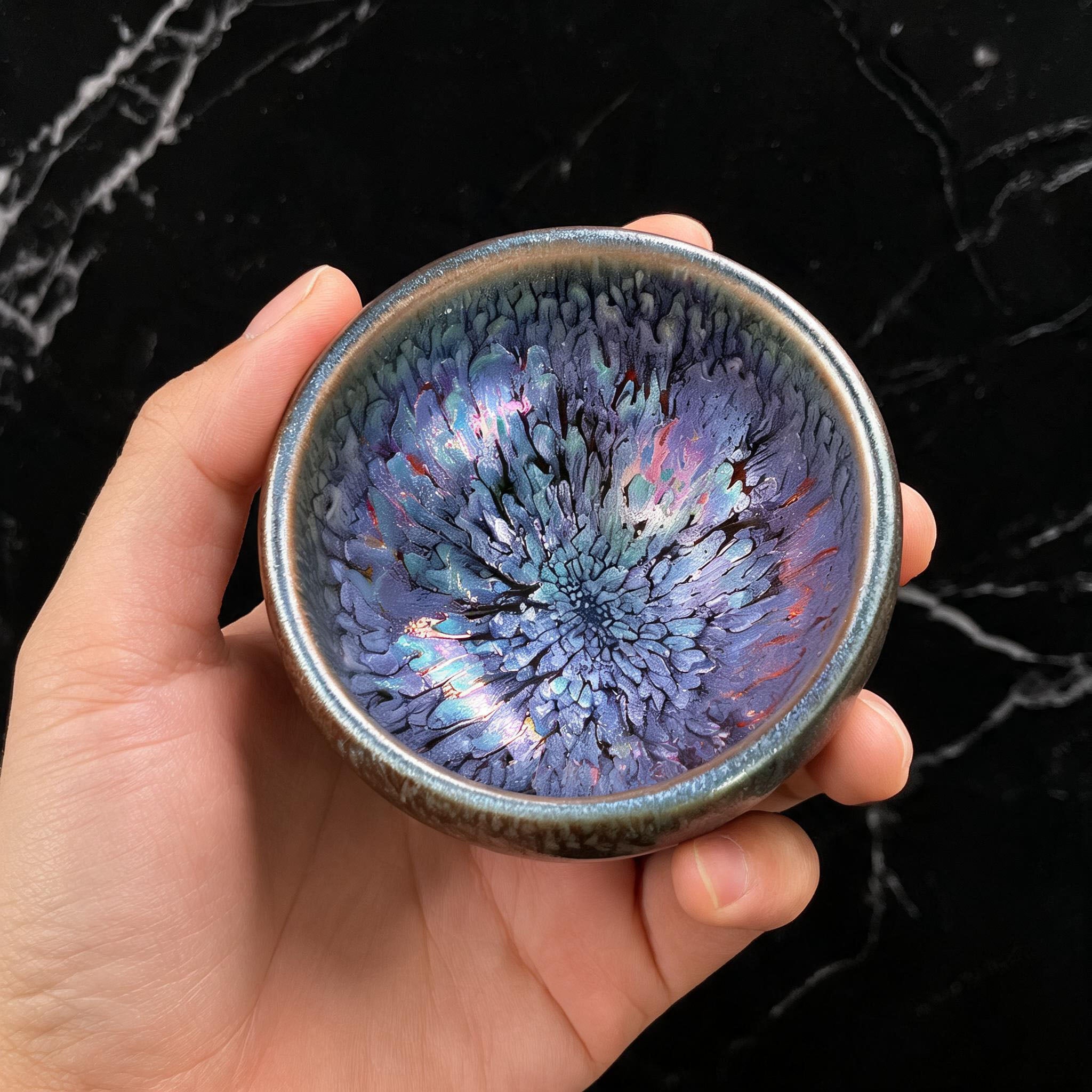 Bottom view of authentic iron-rich clay body of a handcrafted Jian Zhan Tenmoku teacup.