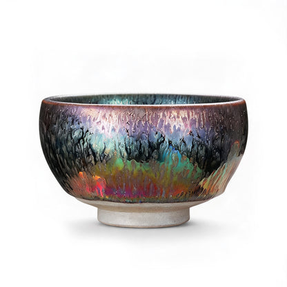 Macro detail of prismatic iron crystals and iridescent luster on a Jianware Tenmoku ceramic bowl.